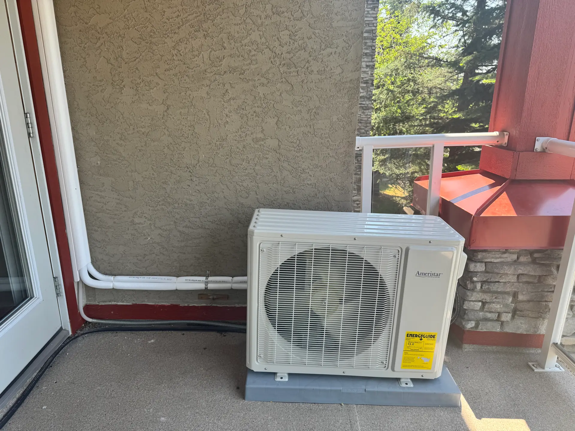 Ductless mini-split outdoor unit installed on a Calgary condo balcony