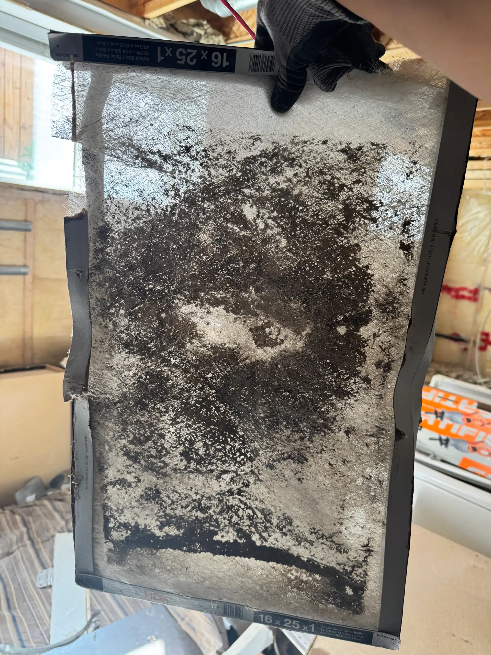 Clogged furnace filter pulled during a Wagner Mechanical maintenance visit