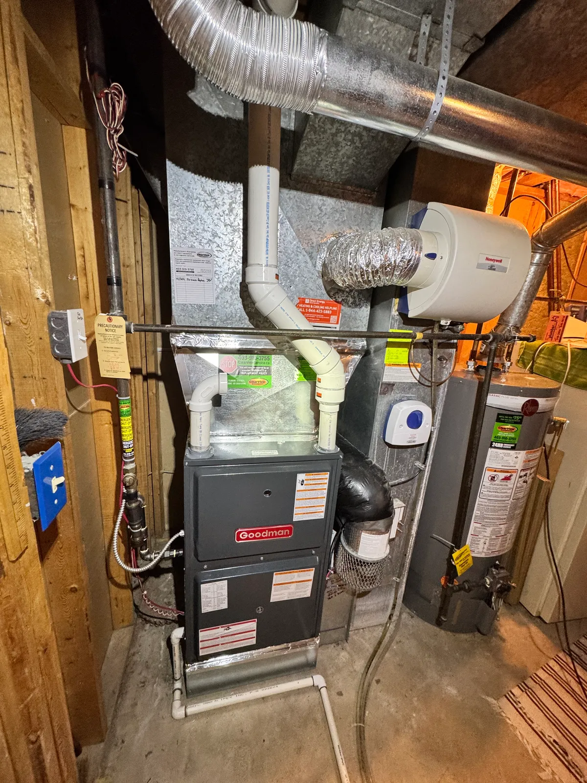 HVAC technician performing a furnace tune-up during a maintenance plan visit at a Calgary home