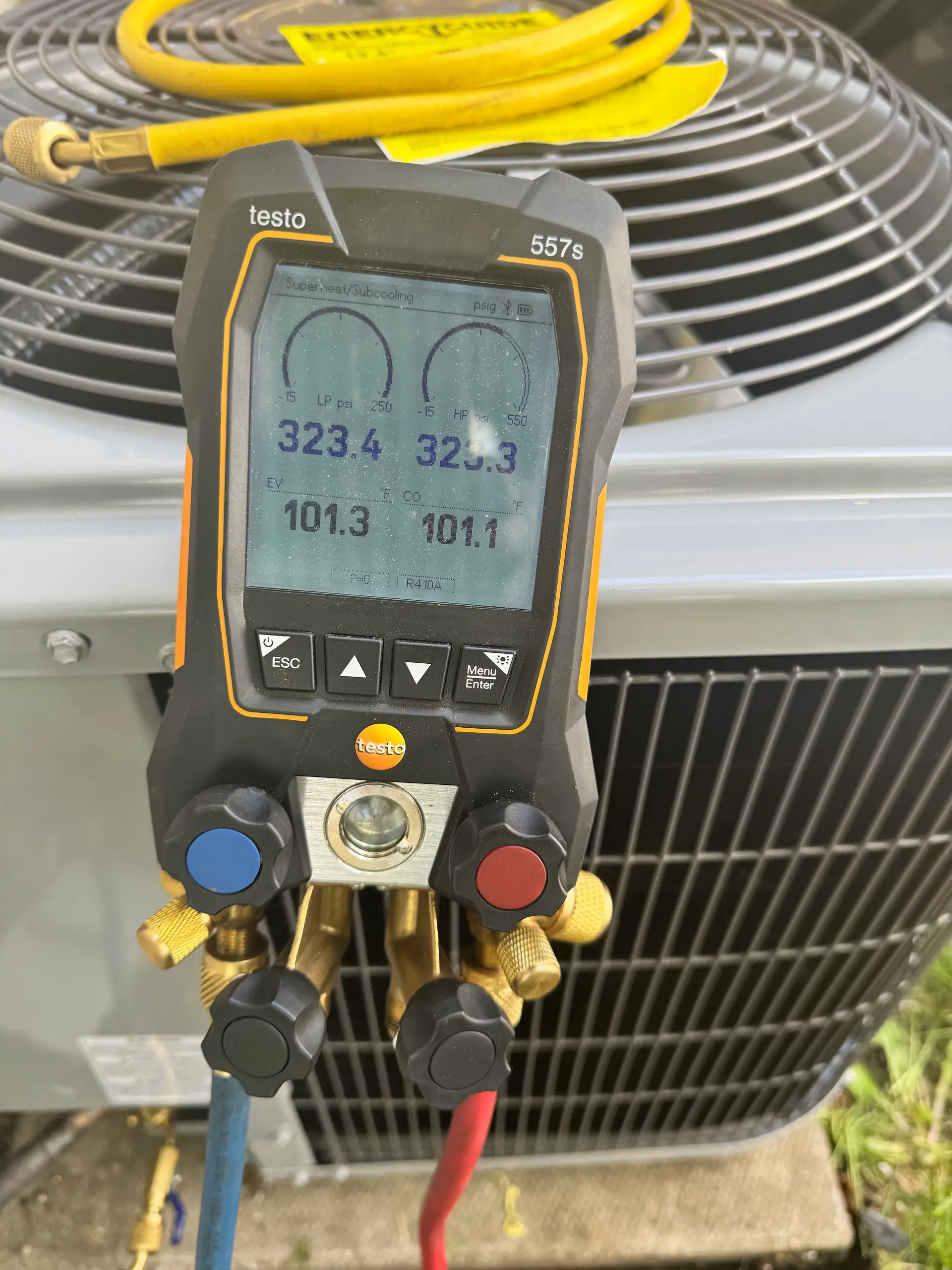 Digital refrigerant gauges reading system pressures on a Calgary air conditioner